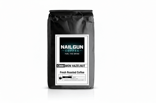 Nail Gun Coffee in a black bag on white background with Cinnamon Hazelnut flavored coffee beans 
