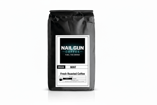 Nail Gun Coffee in a black bag on white background with Mint flavored coffee beans 